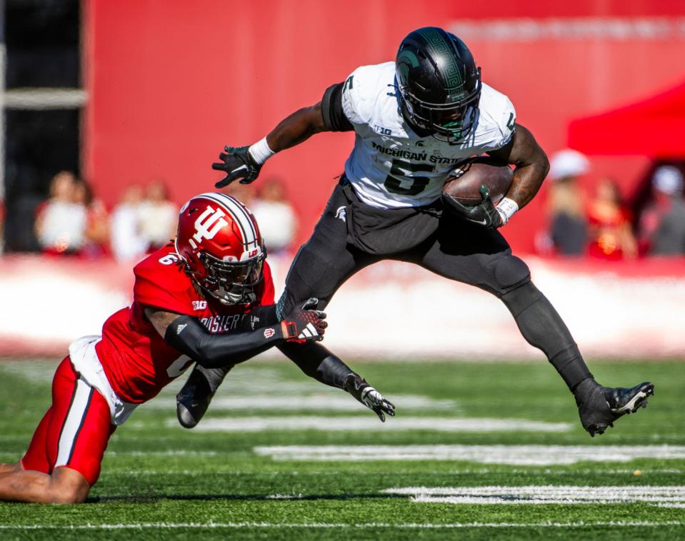 Indiana's Phillip Dunnam (6) tackles Michigan State's Nate Carter (5) during the first half of the Indiana versus Michigan State football game at Memorial Stadium on Saturday, Nov. 18, 2023.