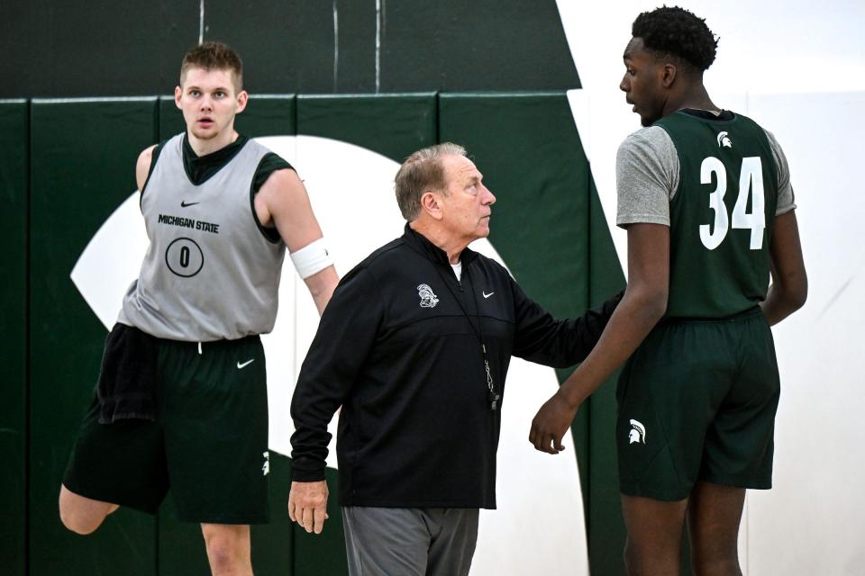Michigan State's head coach Tom Izzo, center, talks with Xavier Booker, right, as Jaxon Kohler, left, looks on during men's basketball media day on Thursday, Oct. 17, 2024, at the Breslin Center in East Lansing.