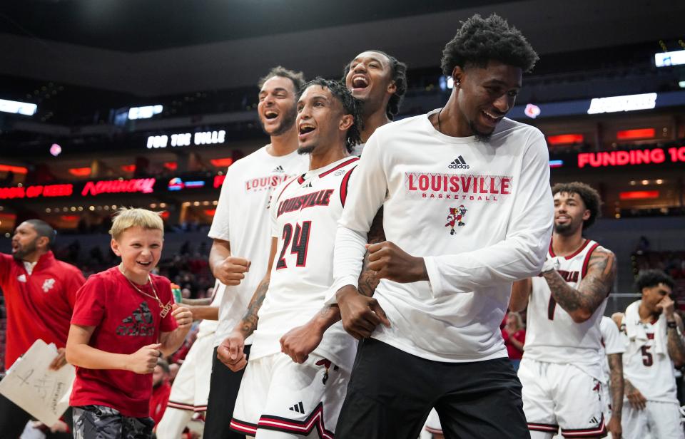 The Louisville bench celebrate late in the the second half as the Cards easily defeated Young Harris College 106-59 in the Louisville Cards' first exhibition game at the KFC Yum! Center in downtown Louisville, Ky. Oct. 21, 2024.