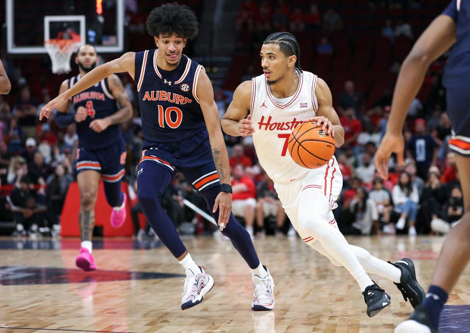 Nov 9, 2024; Houston, Texas, USA; Houston Cougars guard Milos Uzan (7) dribbles the ball as Auburn Tigers guard Chad Baker-Mazara (10) defends during the second half at Toyota Center. Mandatory Credit: Troy Taormina-Imagn Images