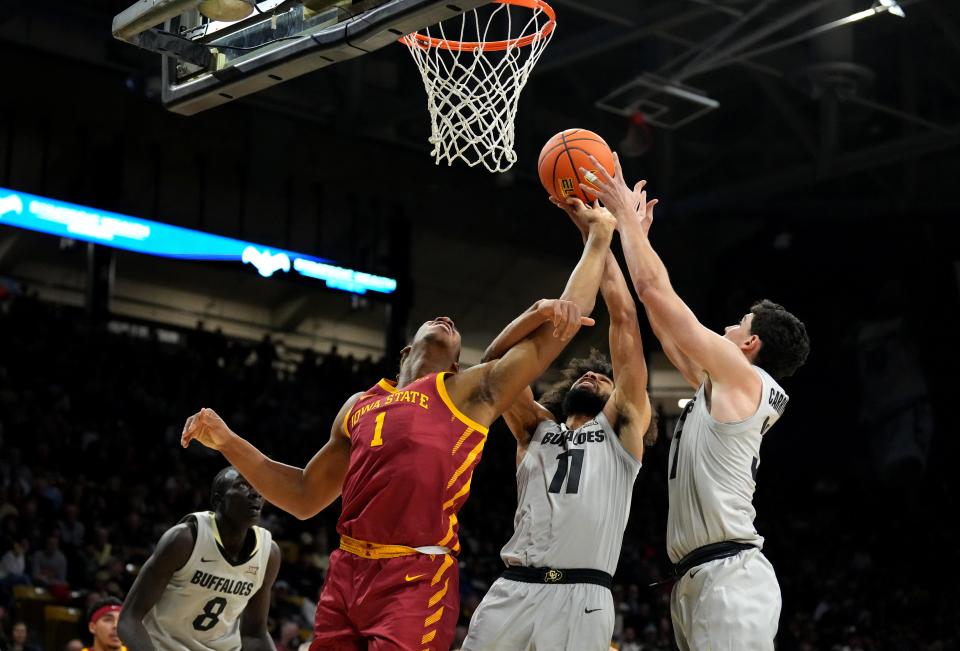 Dec 30, 2024; Boulder, Colorado, USA; Iowa State Cyclones center Dishon Jackson (1) and Colorado Buffaloes guard Javon Ruffin (11) and Colorado Buffaloes guard Harrison Carrington (31) reach for the ball in the first half at CU Events Center. Mandatory Credit: Ron Chenoy-Imagn Images