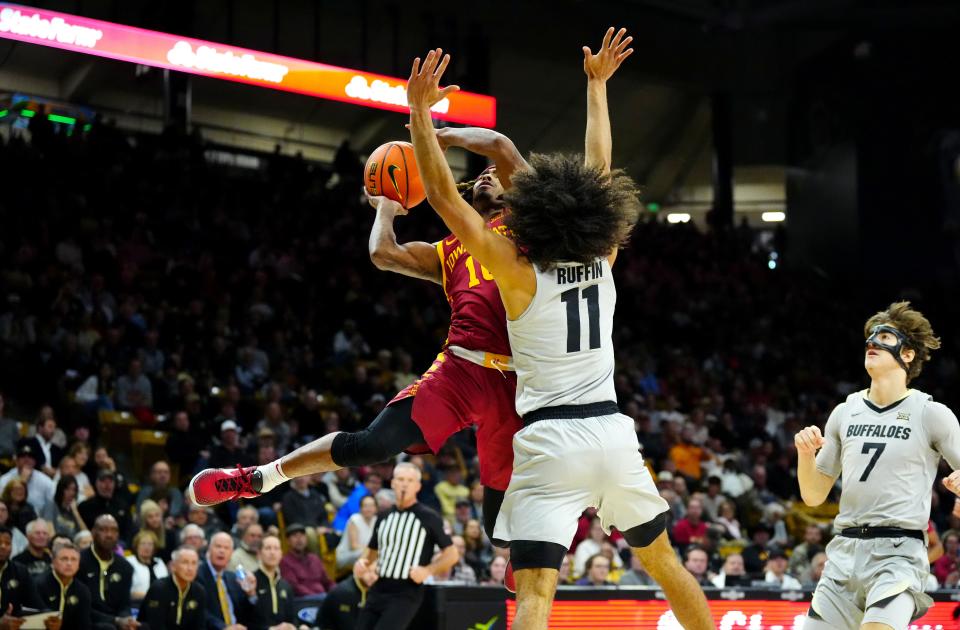 Dec 30, 2024; Boulder, Colorado, USA; Colorado Buffaloes guard Javon Ruffin (11) defends against Iowa State Cyclones guard Keshon Gilbert (10) in the first half at CU Events Center. Mandatory Credit: Ron Chenoy-Imagn Images