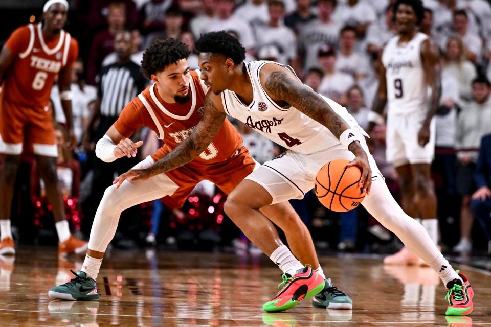 Jan 4, 2025; College Station, Texas, USA; Texas A&M Aggies guard Wade Taylor IV (4) controls the ball as Texas Longhorns guard Jordan Pope (0) defends during the second half at Reed Arena. The Aggies defeated the Longhorns 80-60. Mandatory Credit: Maria Lysaker-Imagn Images