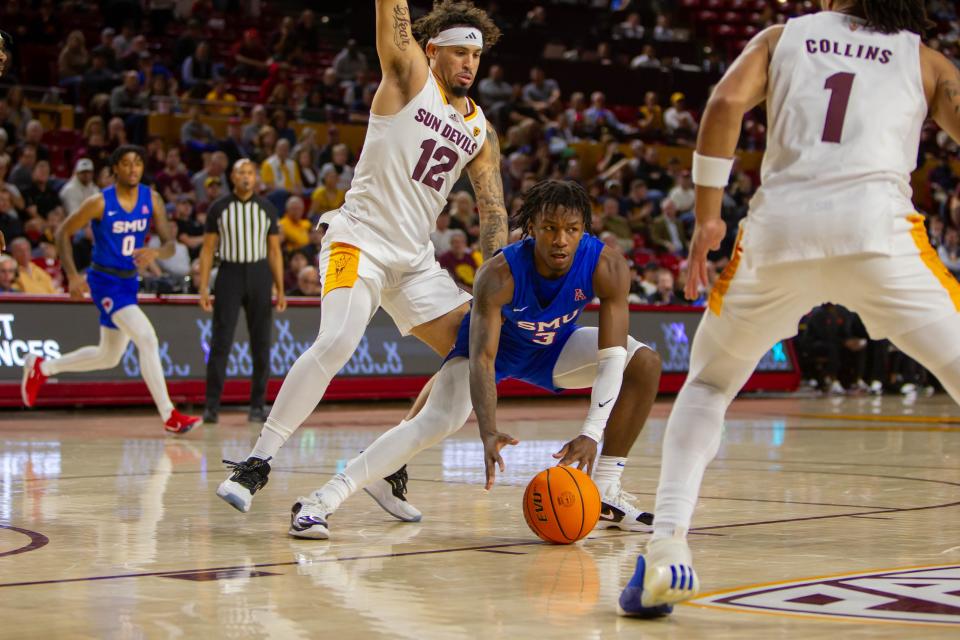 SMU's Chuck Harris (3) grabs the ball at Desert Financial Arena in Tempe on Dec. 6, 2023.
