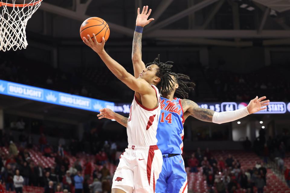 Jan 8, 2025; Fayetteville, Arkansas, USA; Arkansas Razorbacks guard D.J. Wagner (21) shoots against Ole Miss Rebels guard Dre Davis (14) in the second half at Bud Walton Arena. Ole Miss won 73-66. Mandatory Credit: Nelson Chenault-Imagn Images