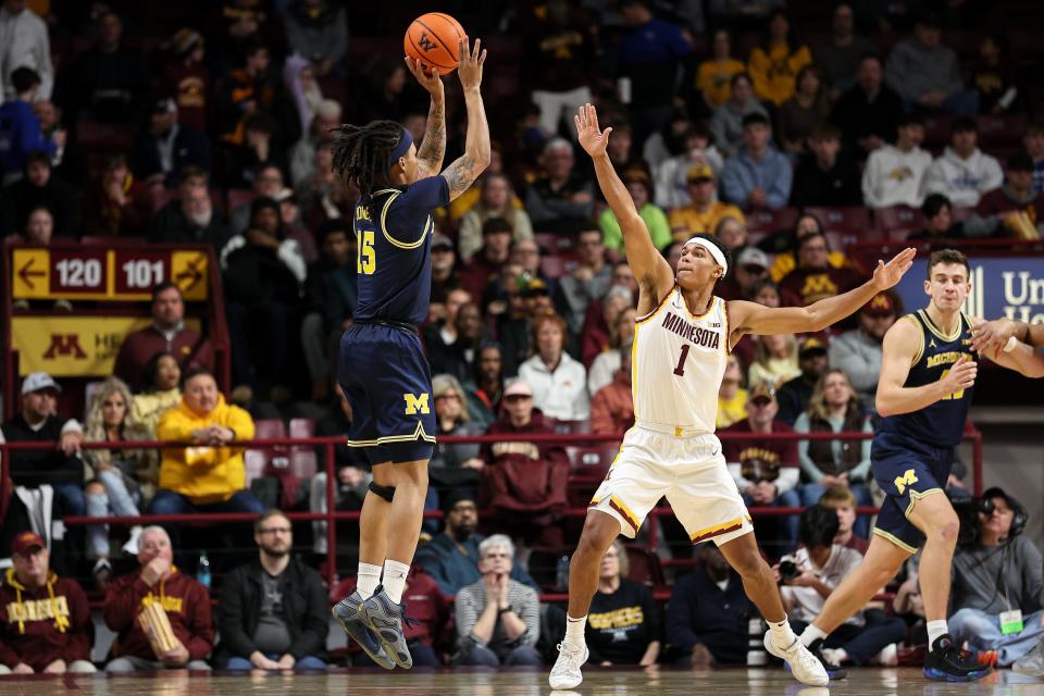 Michigan Wolverines guard Rubin Jones (15) shoots as Minnesota Golden Gophers guard Isaac Asuma (1) defends during the first half at Williams Arena in Minneapolis on Thursday, Jan. 16, 2025.
